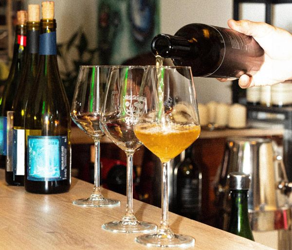Wine being poured at the bar of SHIUA, wine bar and enoteca in Milan